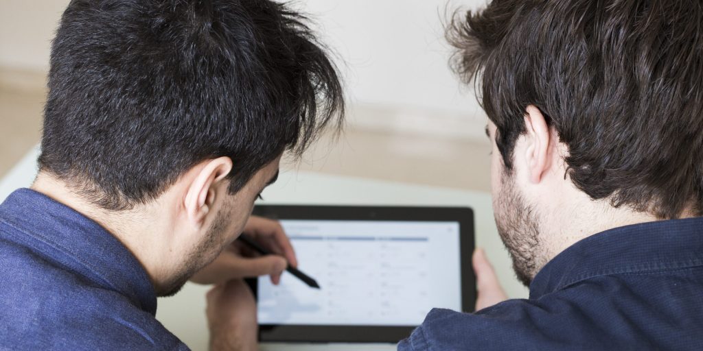 anonymous-man-discussing-data-tablet